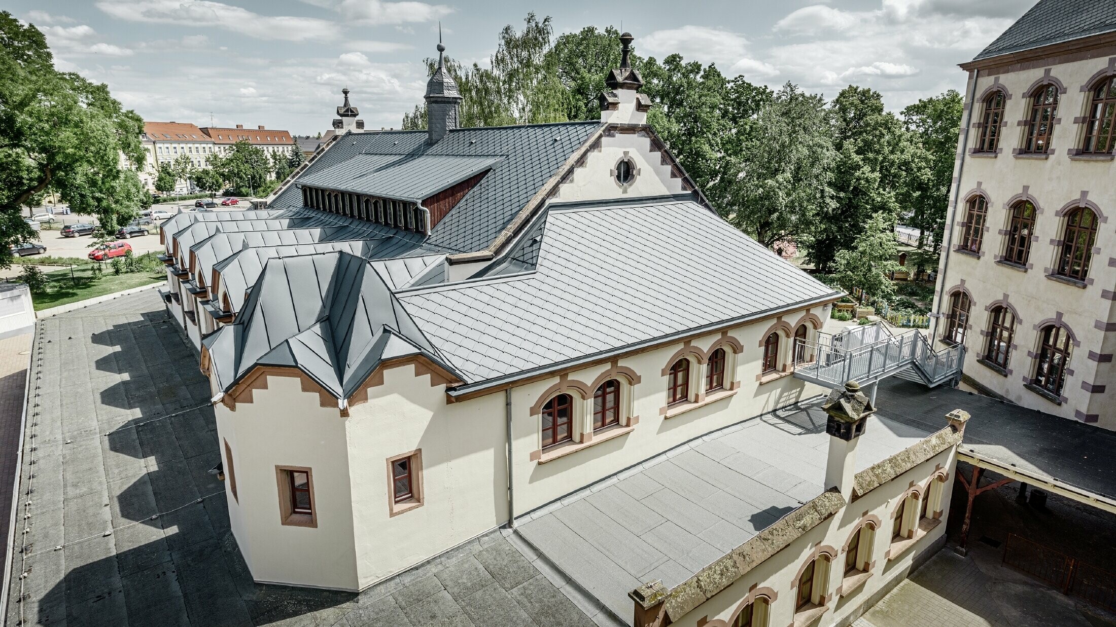 frisch sanierte Turnhallte der Schule Lutherstadt Wittenberg mit einem PREFA Aluminiumdach, verlegt wurden die Dachraute und Prefalz in anthrazit