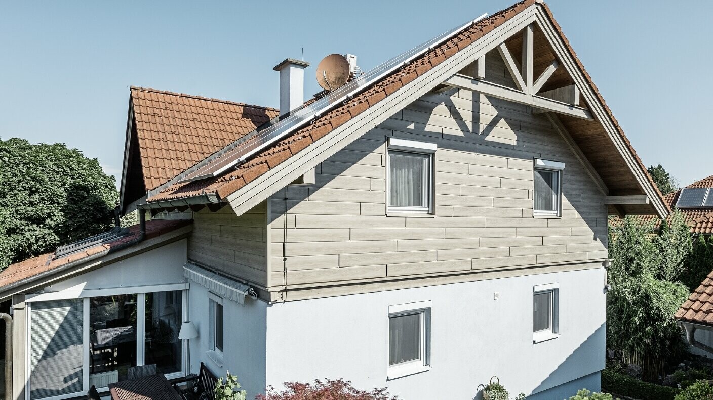 Frisch sanierte Fassade mit hinterlüfteter Alufassade im Obergeschoß; Der Giebel wurde mit Sidings in Holzoptik (Eiche beige-grau) verkleidet. 